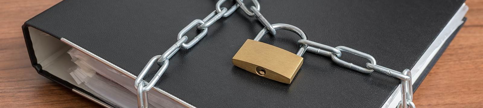 a black binder with a chain and padlock